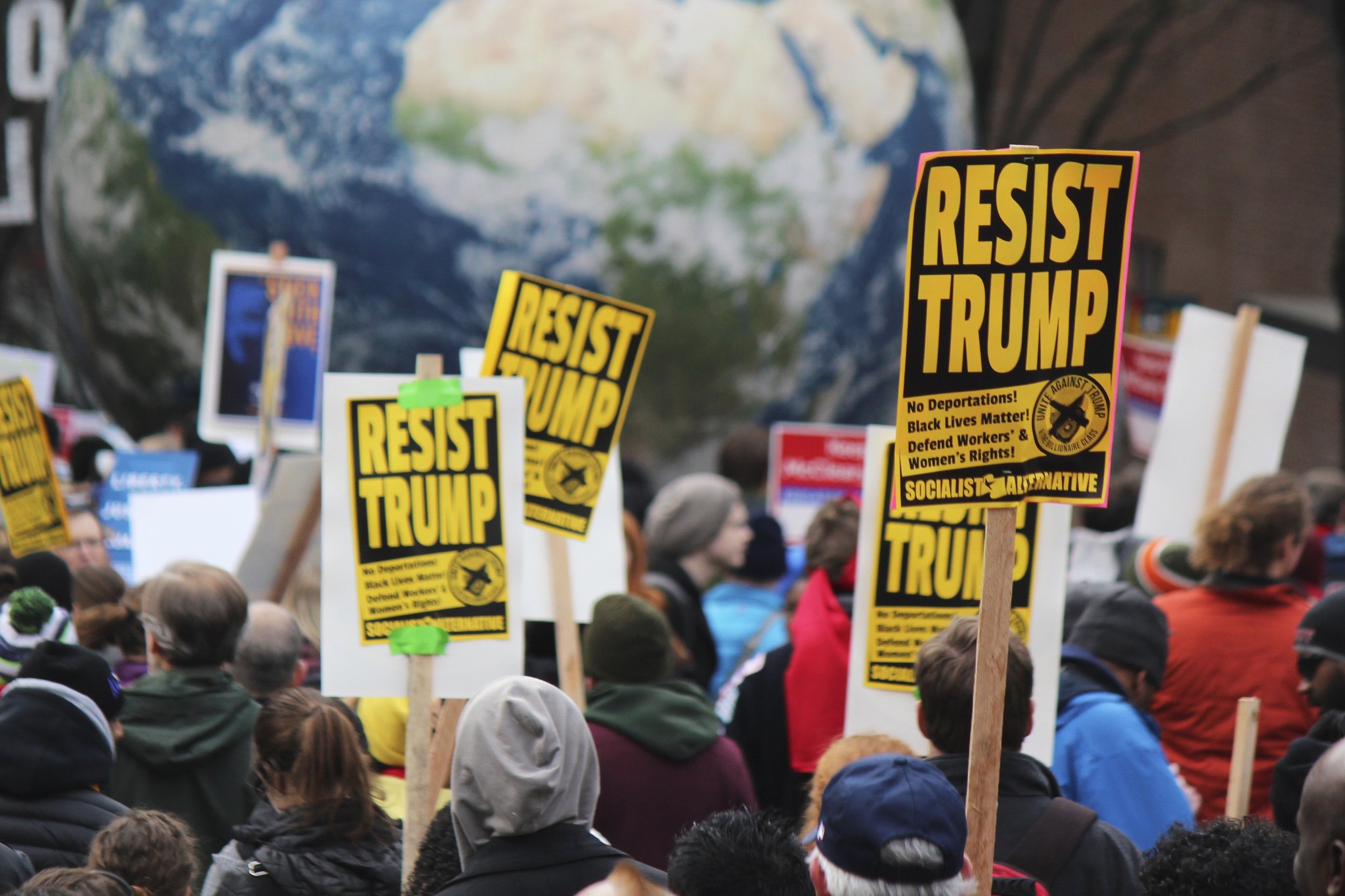 Activists hoist Socialist Alternative signs during the Martin Luther King, Jr. Day March on January 16, 2017. Photo by Sara Bernard.