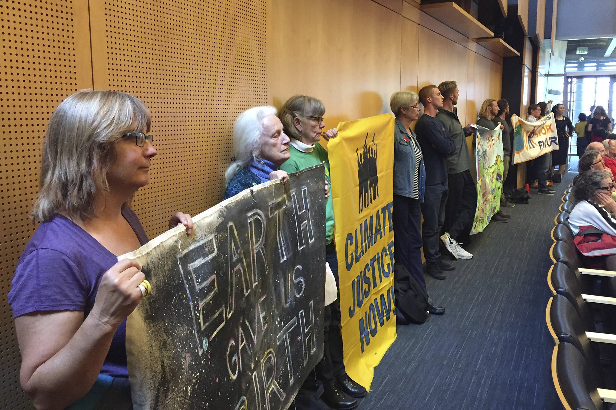 Climate activists line the walls at a City Council meeting on June 12. Photo by Sara Bernard