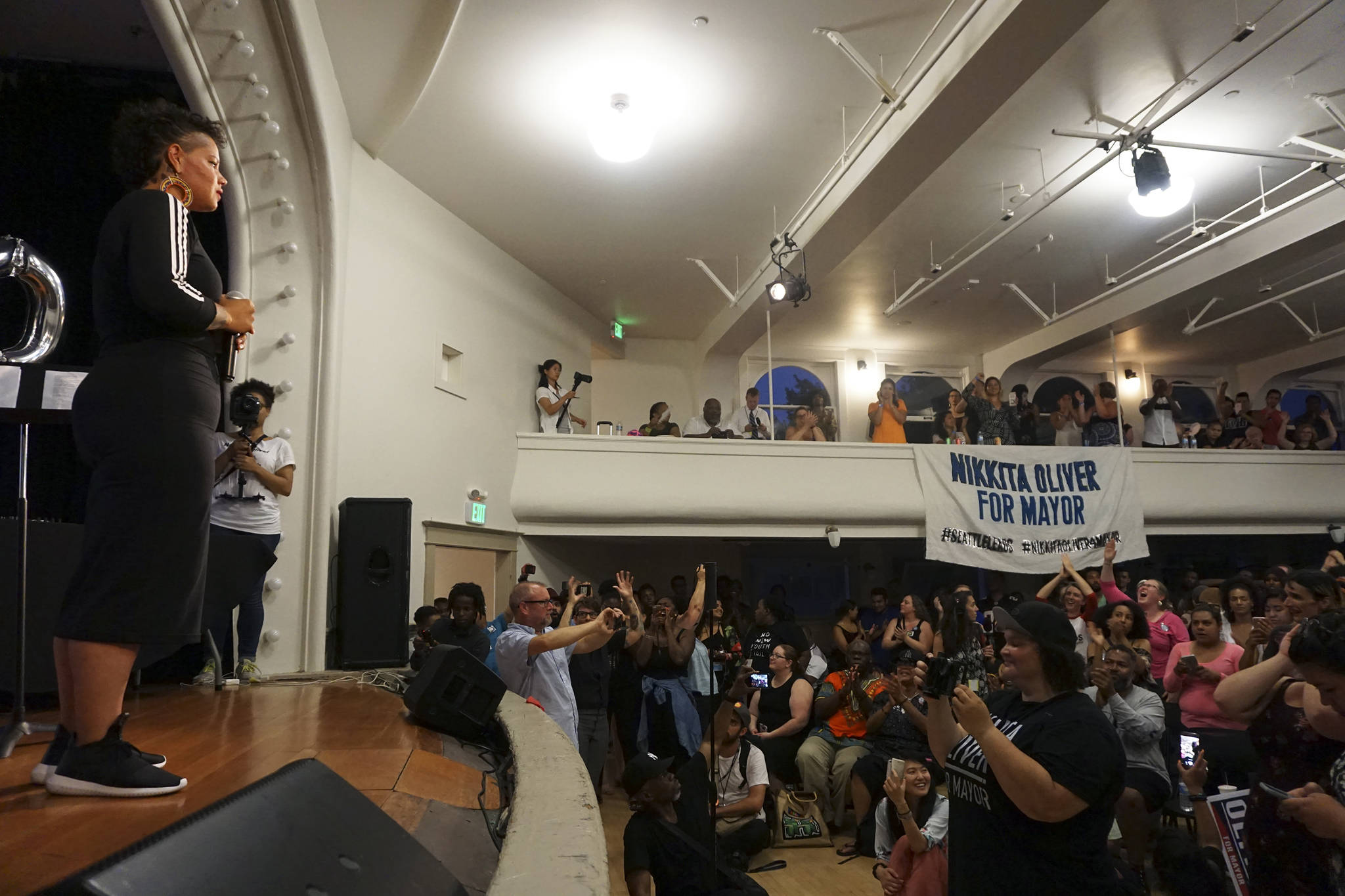 Nikkita Oliver takes the stage at her primary election night party. Photo by Casey Jaywork