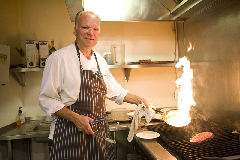 Chef Szmania seasons and cooks a New York steak.