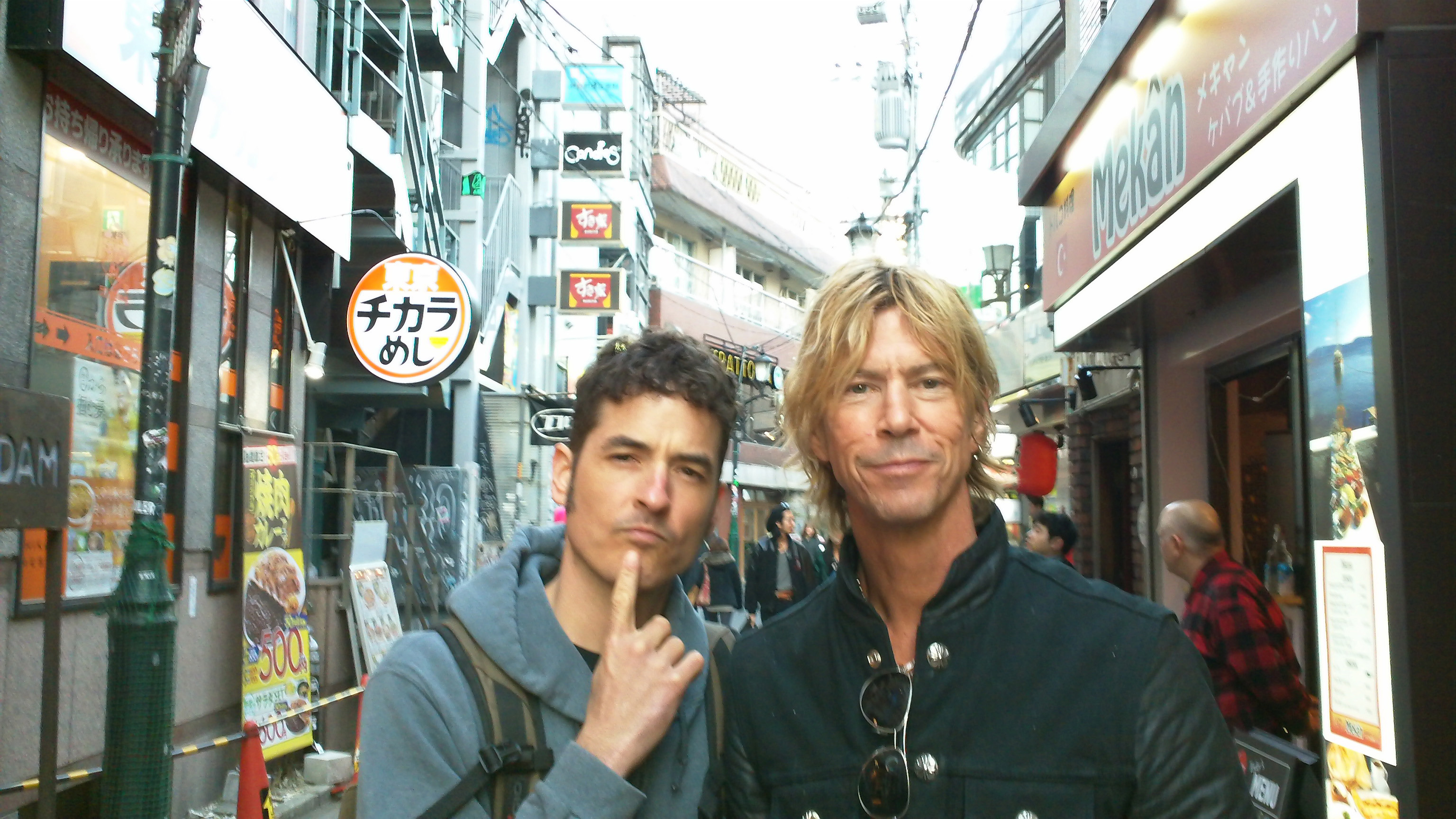 The author, right, on a shopping spree in Tokyo with drummer Burke Thomas.