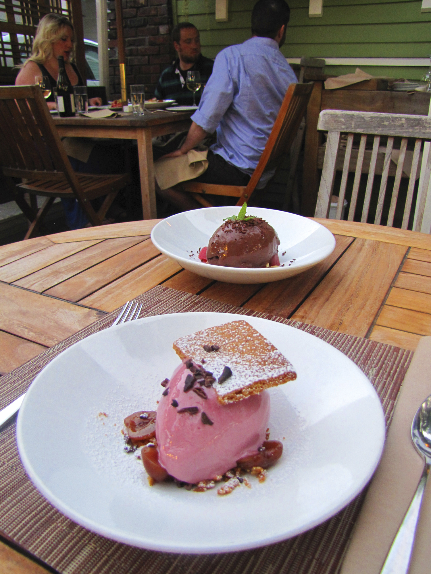 Front: cherry frozen yogurt, Graham cracker, compressed cherry, cacao nib at Tilth. Background: chocolate hazelnut sorbet with Theo dark chocolate, rhubarb, lavender mint.