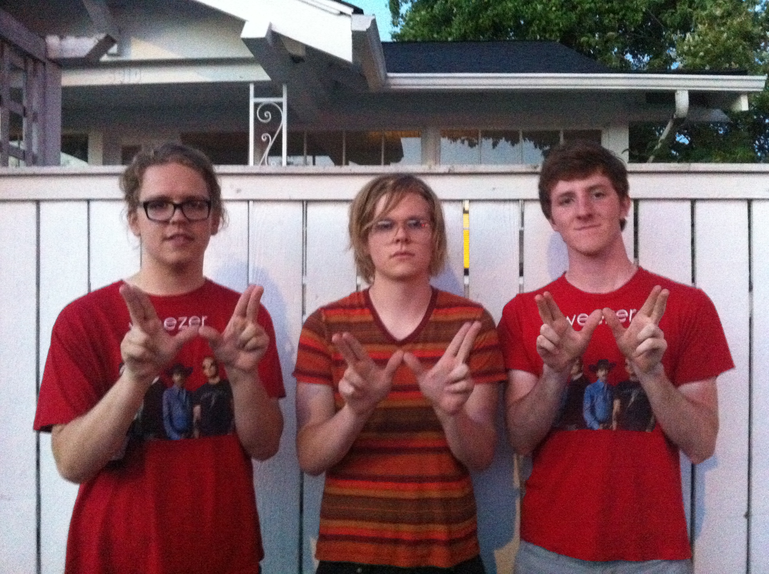 Josh Davis, Mike Davis, and Justin Salisbury salute Weezer.