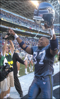 New father Shaun Alexander celebrates at Seahawks Stadium.