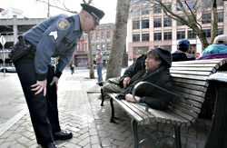 SPD Sgt. Paul Gracy checks in on a homeless man in Pioneer Square. On a recent subfreezing night, police scoured the city for people who needed shelter, and for scarce shelter space itself.