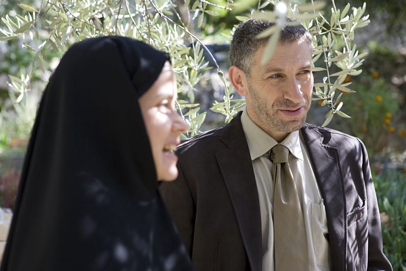 Ivanir's executive, at right, learns about Christian burial practices.