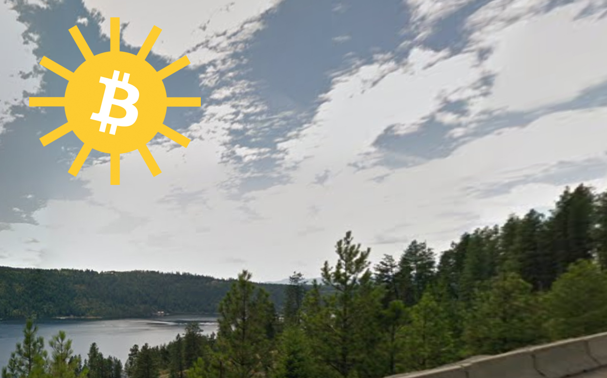 A shining Bitcoin Sun illuminates your potential future Lake Coeur d'Alene property.