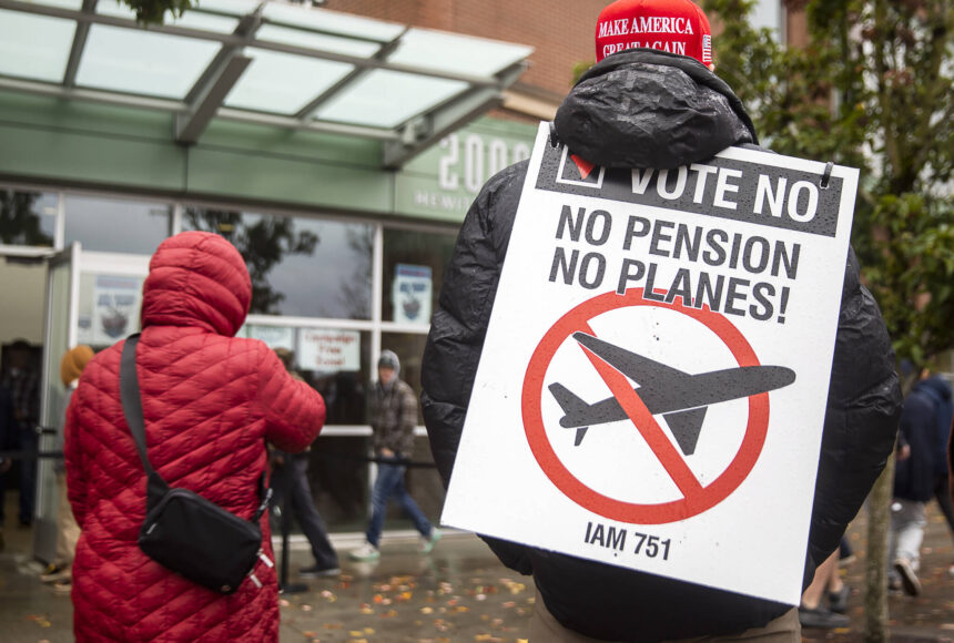 <p>Larry Best, a customer coordinator for quality assurance who has worked at Boeing for 38 years, stands outside of Angel of the Winds Arena with a “vote no” sign on Monday in Everett. (Olivia Vanni / The Herald)</p>